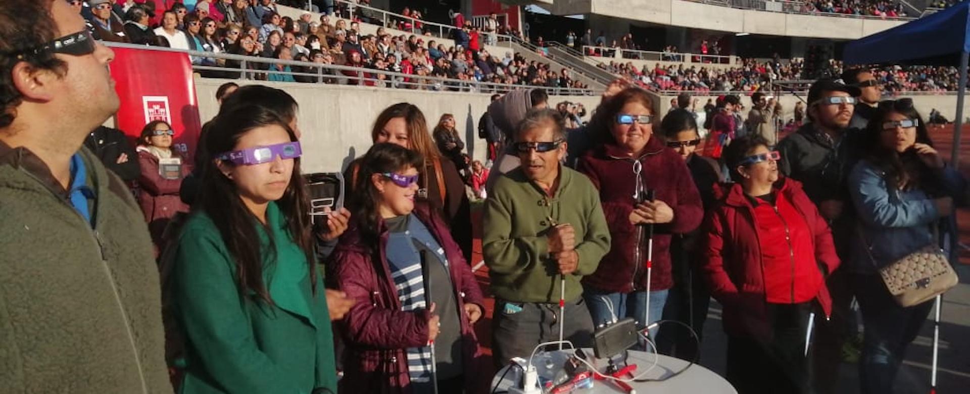 A group of people with visual impairments experiencing a total solar eclipse 